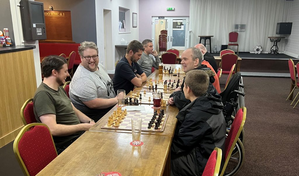 Club members playing chess together